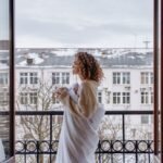 Woman wrapped in a blanket feeling cold on a winter morning