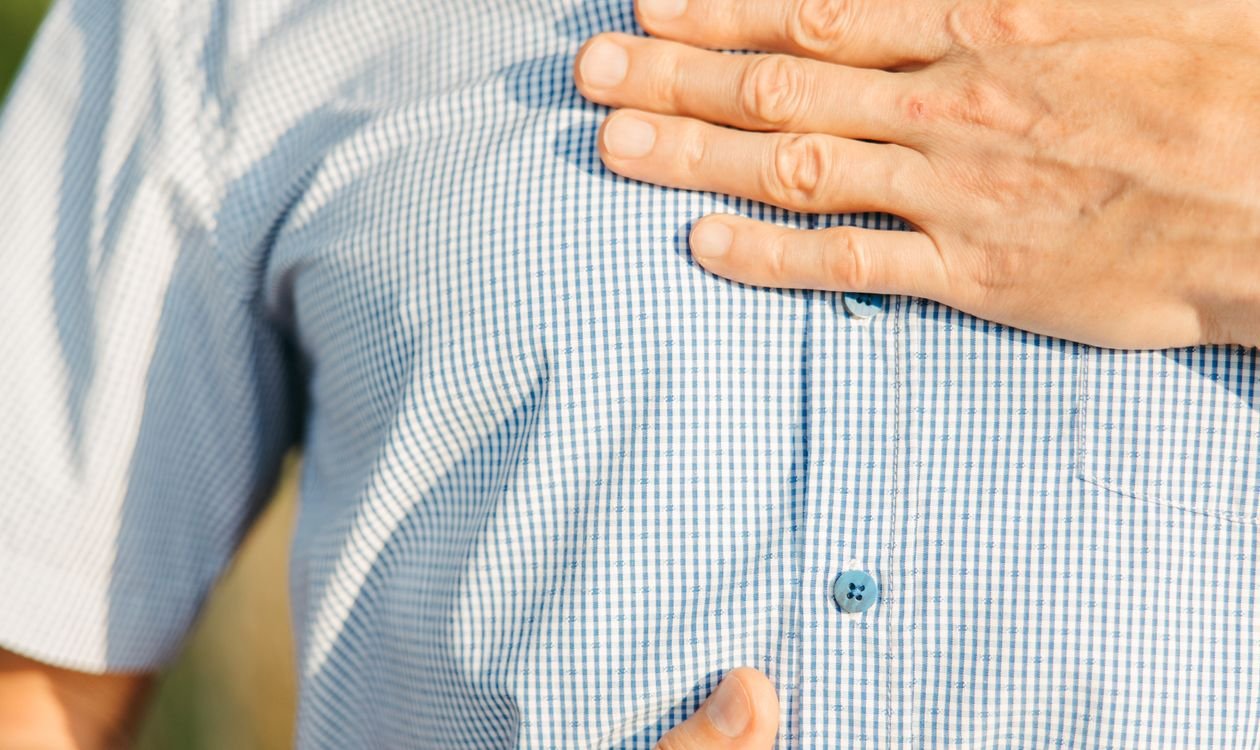 Person holding stomach, feeling unwell