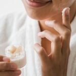 Close-up of a person applying facial cream as part of a skincare routine